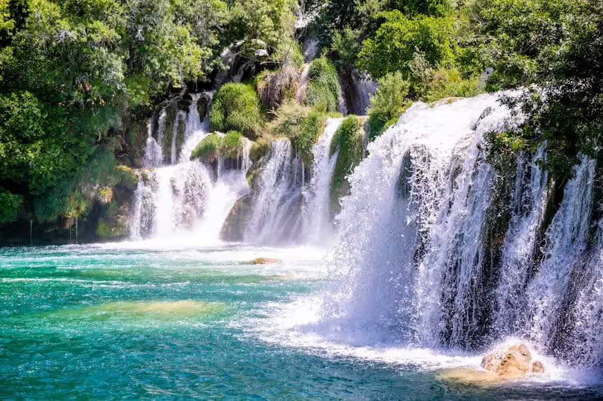 Panoramic Krka Waterfalls cascades into turquoise pool at Krka National Park on a private day trip tour