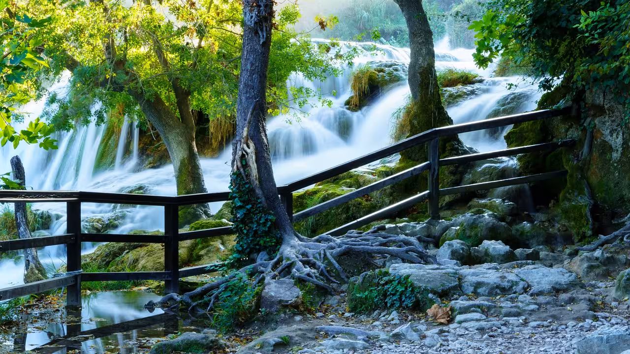 Wooden walkway by Krka Waterfalls in Krka National Park, scenic day trip from Zadar to Skradin