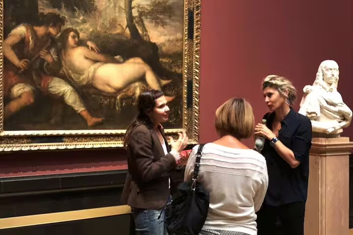 Visitors discussing a masterpiece in the Kunsthistorisches Museum, Vienna, during a private guided tour.