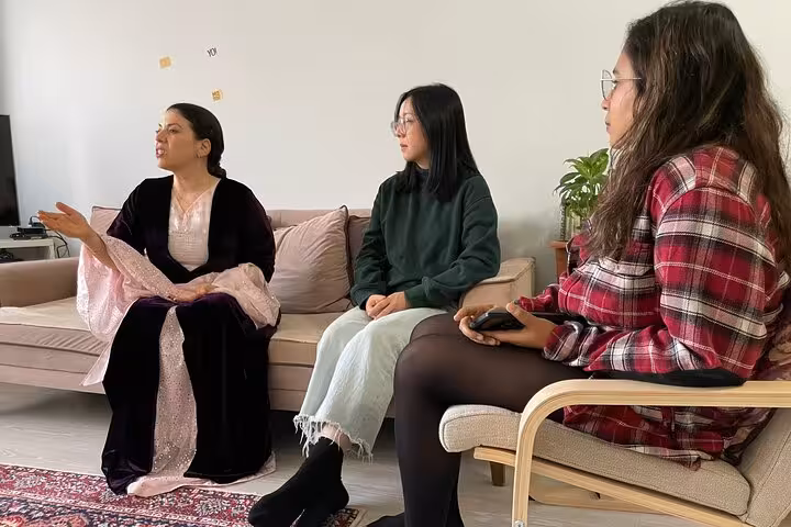 Guests listen to a Kurdish dengbêj singer in a private Istanbul home music session and cultural tour
