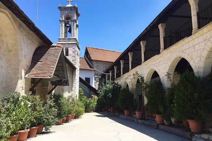 Kykkos Monastery cloister walkway with arches and potted plants on Troodos day trip from Paphos