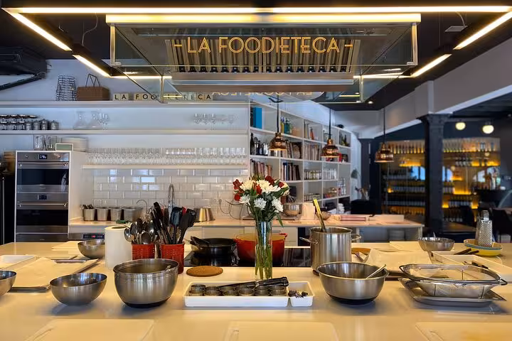 Modern kitchen setup in La Foodieteca loft, showcasing cookware for the La Boqueria Market Tour & Premium Cooking Class.