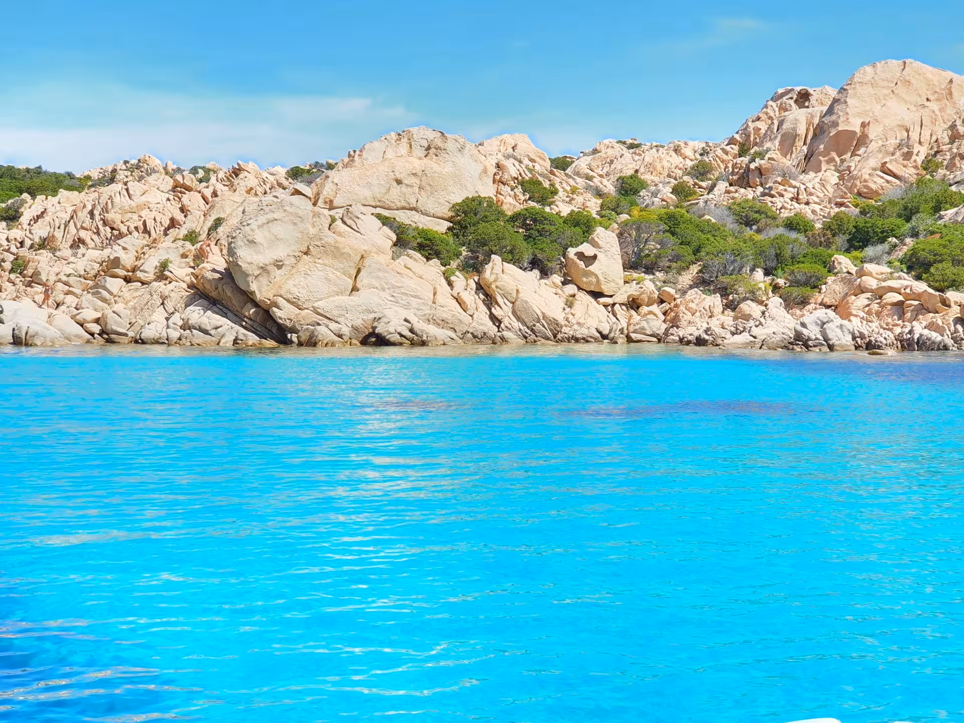 Vibrant blue waters and rugged cliffs in La Maddalena Archipelago, ideal for an adventurous RIB boat tour.