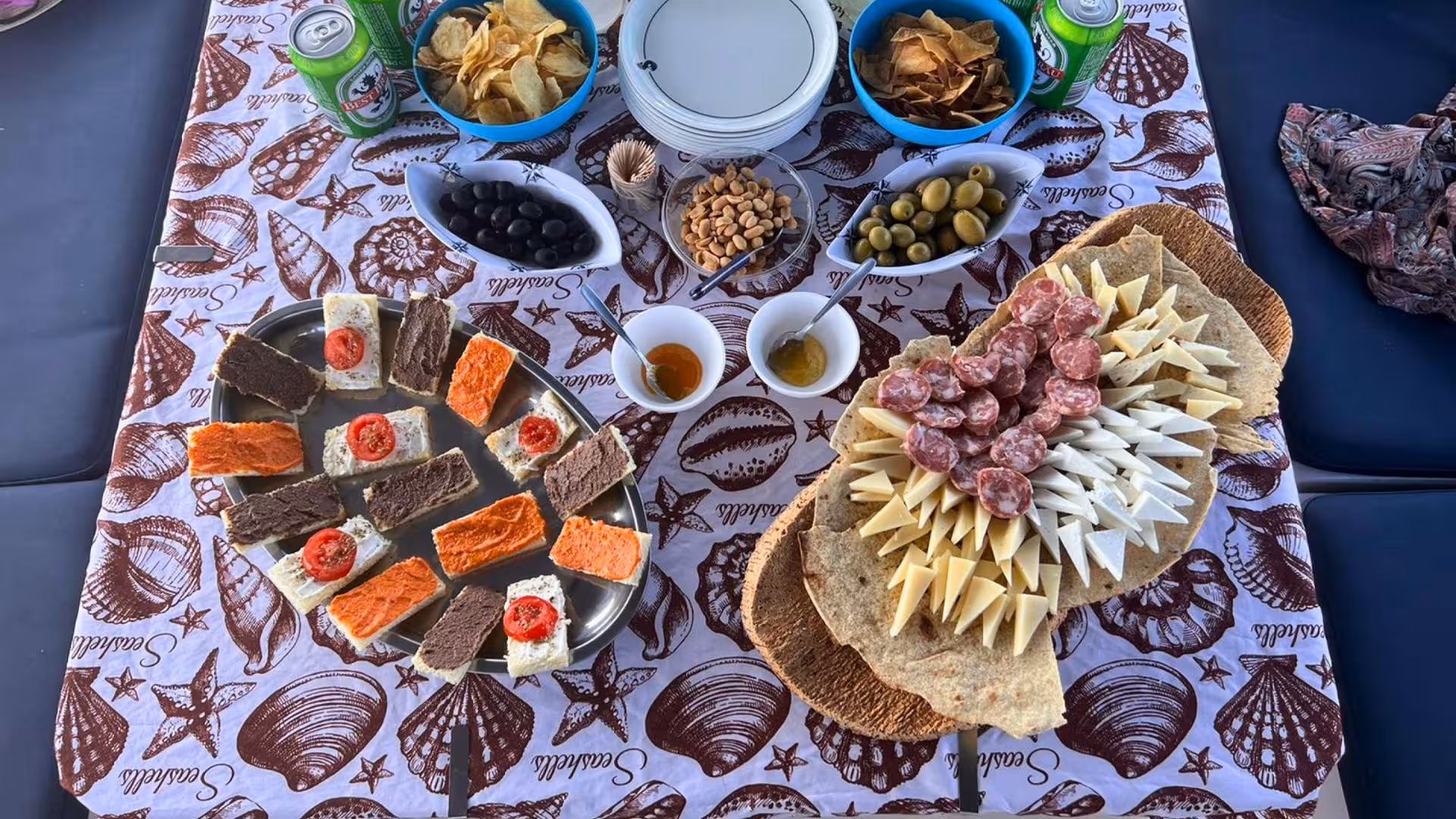 Delight in a Mediterranean spread with cheeses, meats, and olives aboard the La Maddalena catamaran excursion.