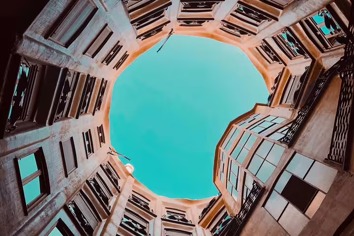 View of the sky through La Pedrera’s inner courtyard, showcasing its architectural grandeur on the private tour.