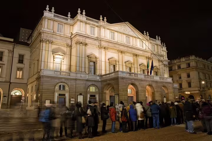 La Scala Opera House in Milan elegantly lit at night, attracting visitors during a private night tour.