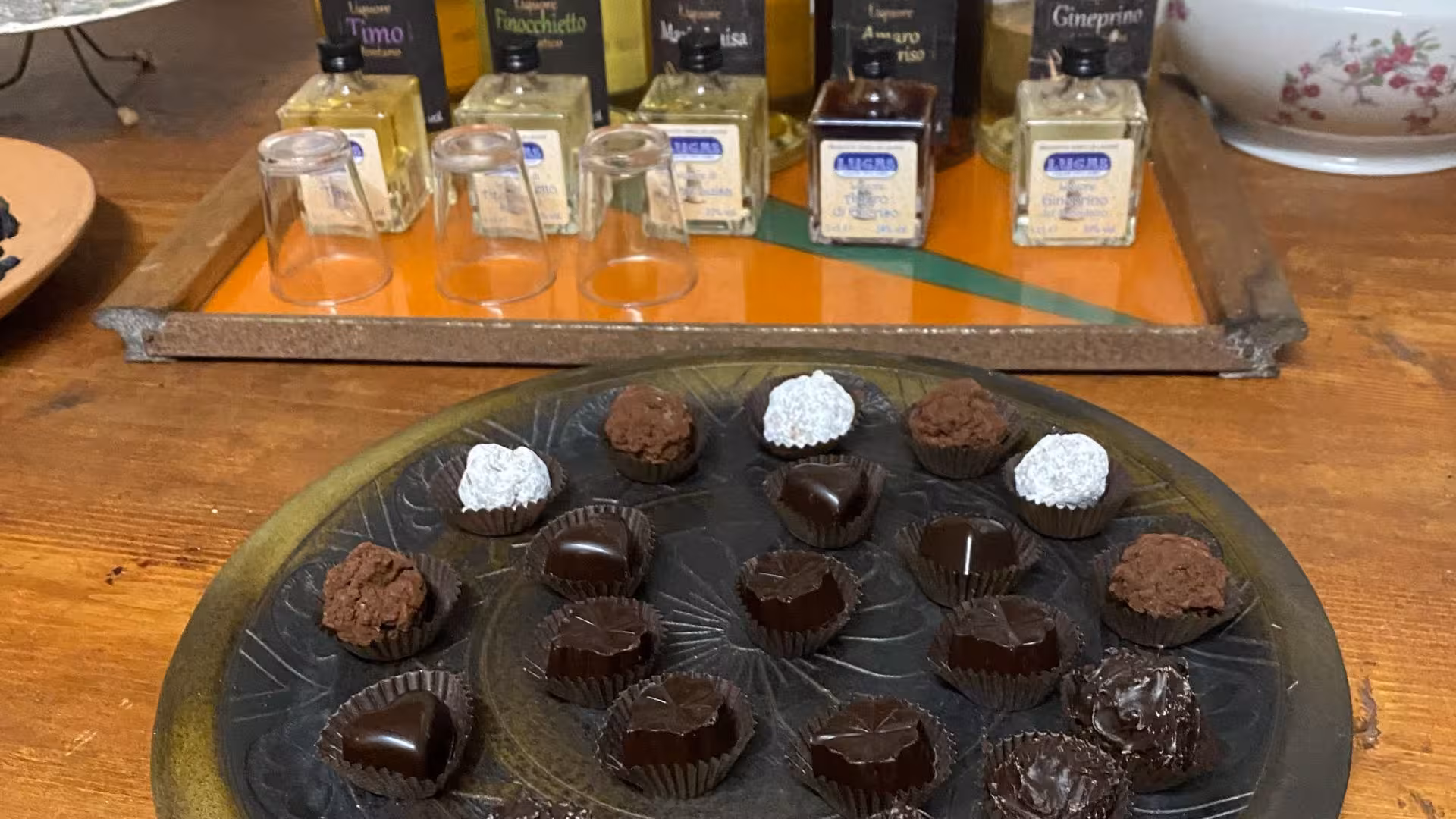 Variety of artisanal chocolates paired with local liqueurs set up for Laconi tasting event.