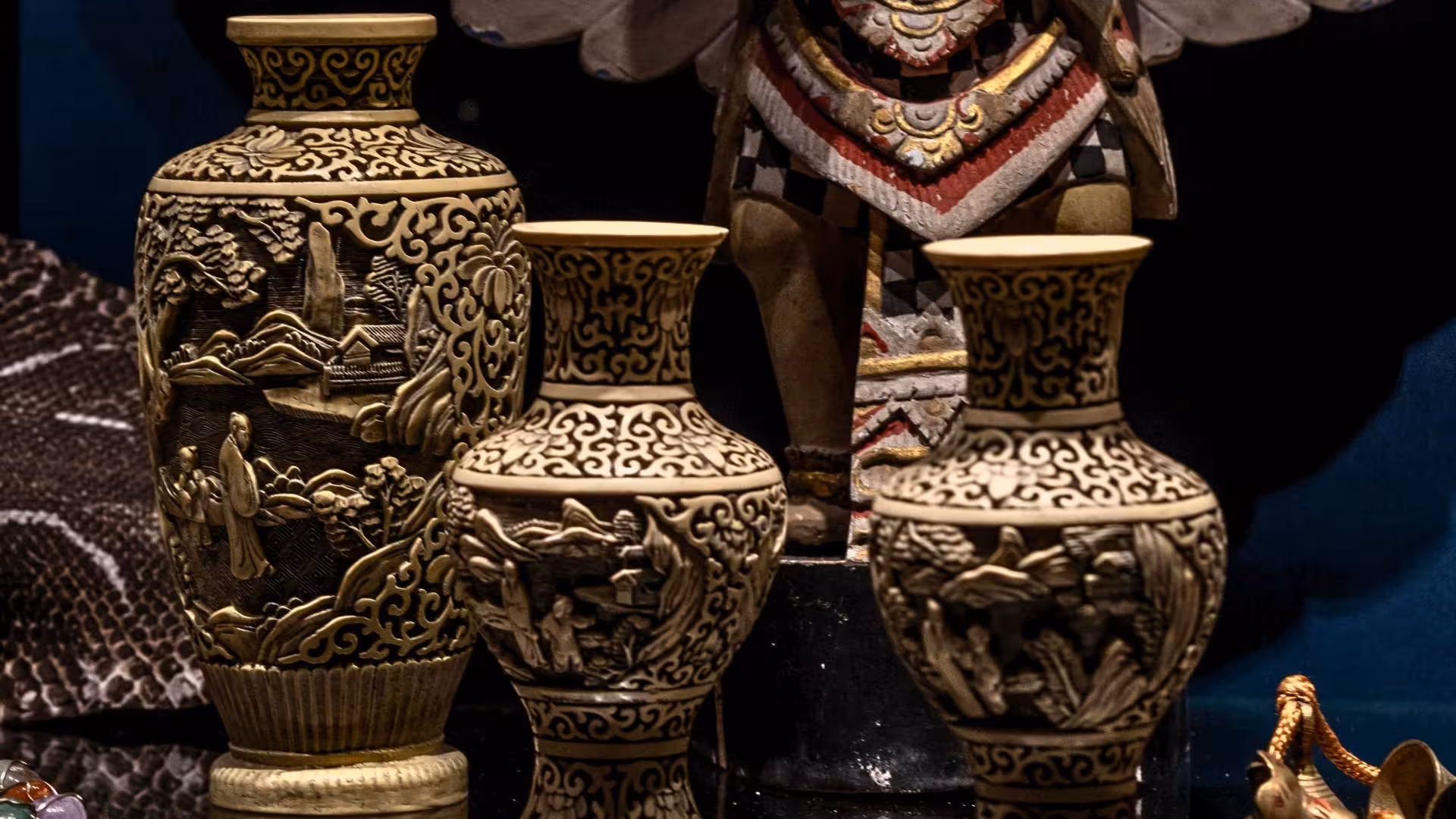 Ornate ceramic vases with detailed carvings displayed in Laconi, reflecting local craftsmanship and cultural richness.