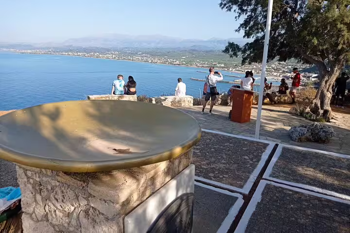 Tourists enjoying the coastal view from a scenic overlook near Lady of the Angels Monastery and Falasarna Beach.