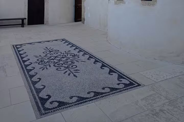 Elegant stone floor mosaic enhances the tranquil interior of Lady of the Angels Monastery, inviting peaceful reflection.