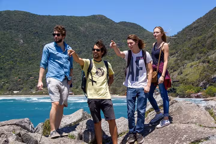 Group of hikers enjoying scenic views at Lagoinha do Leste during a photography adventure tour.
