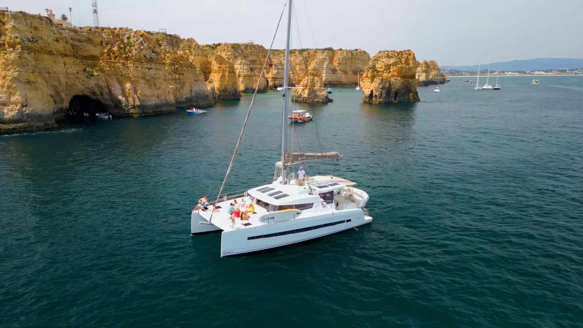 Aerial view of catamaran sailing near Ponta da Piedade cliffs, Lagos daytime sailing tour in Algarve