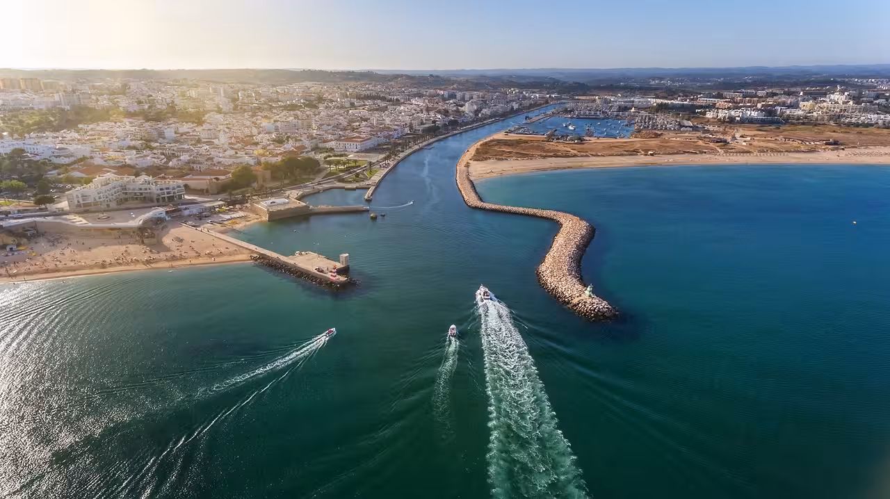 Aerial view of Lagos coastline and harbor entrance, ideal waters for a family fishing trip in the Algarve
