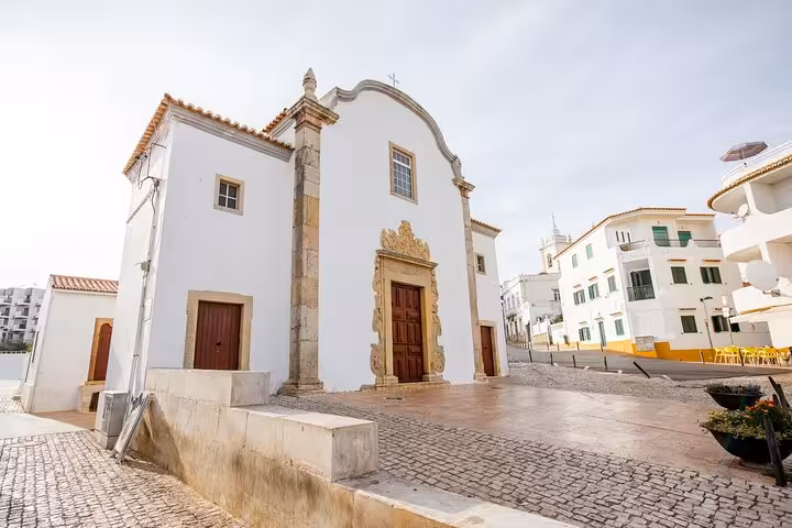 Charming historic church in Lagos with intricate stonework, perfect for cultural exploration on a guided city walk.