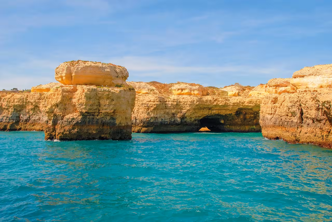 Scenic Lagos Algarve coastline with golden limestone cliffs and turquoise sea on sunset boat tour