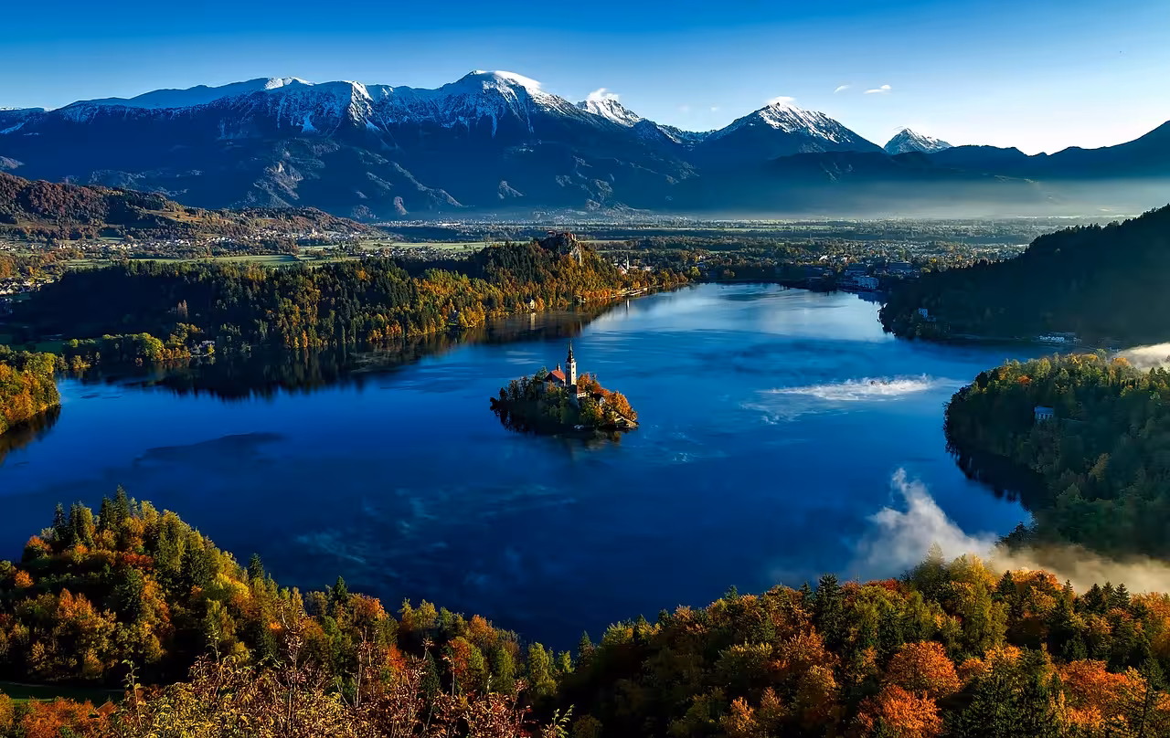 Panoramic Lake Bled with island church and Julian Alps backdrop, must-see on Ljubljana and Bled day trip