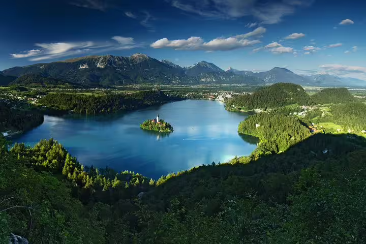 Panoramic Lake Bled summer tour viewpoint showing Bled Island church and alpine mountains, ideal boat ride scene
