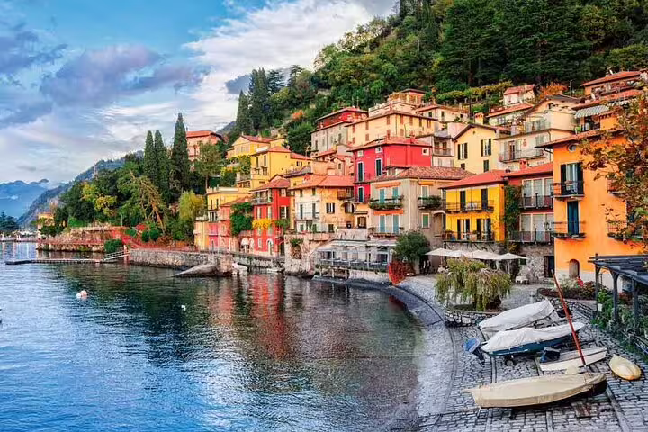 Colorful lakeside village with vibrant buildings along Lake Como's scenic shoreline, perfect for a private tour.