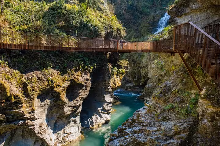 Scenic gorge footbridge and waterfall near Lake Como on Bellagio and Varenna day tour from Milan