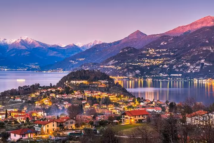 Panoramic Lake Como at sunset with villages and alpine peaks, scenic cruise view on Milan day tour
