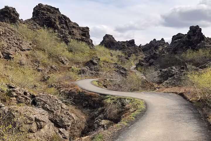 Winding path through rugged lava formations in Dimmuborgir, a highlight of Lake Myvatn private day tour.