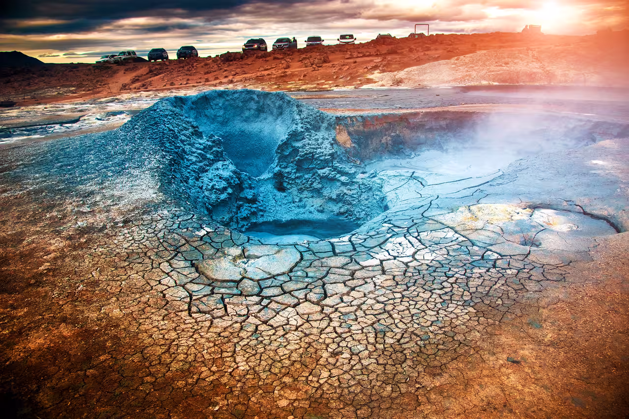 Geothermal landscape at Lake Myvatn with steaming hot spring and cracked earth, featured in a private tour from Akureyri.