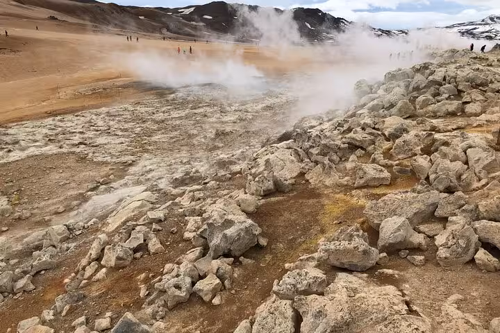 Steaming geothermal landscape at Lake Myvatn with rocky terrain, perfect for a private tour from Akureyri.