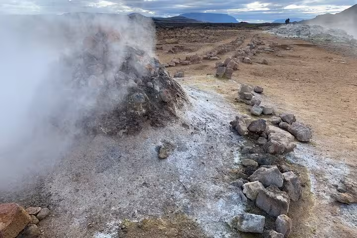 Steaming geothermal area at Lake Myvatn showcasing volcanic activity on a private day tour.