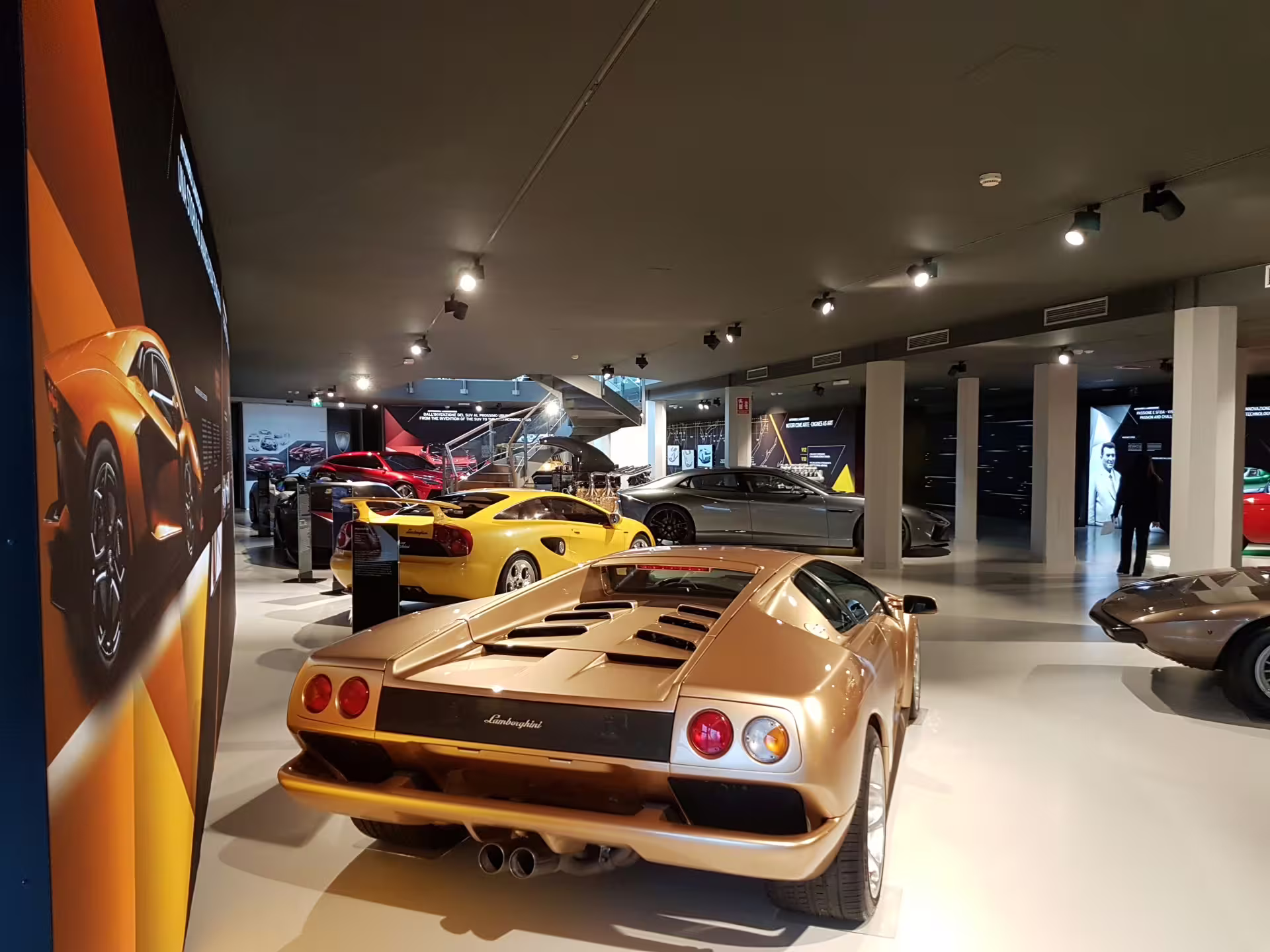Lamborghini Museum Bologna exhibit with classic gold Lamborghini and supercars, entry ticket included