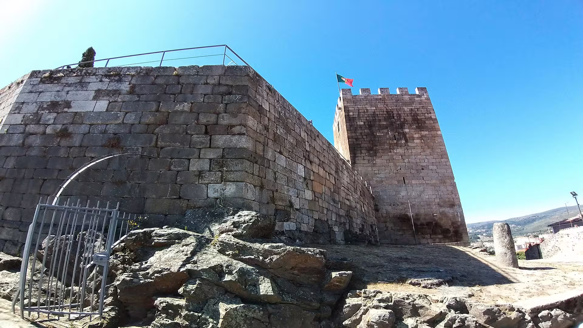 Ancient stone castle with Portuguese flag in Lamego, highlighting historic charm on a private tour of the Dão wine region.