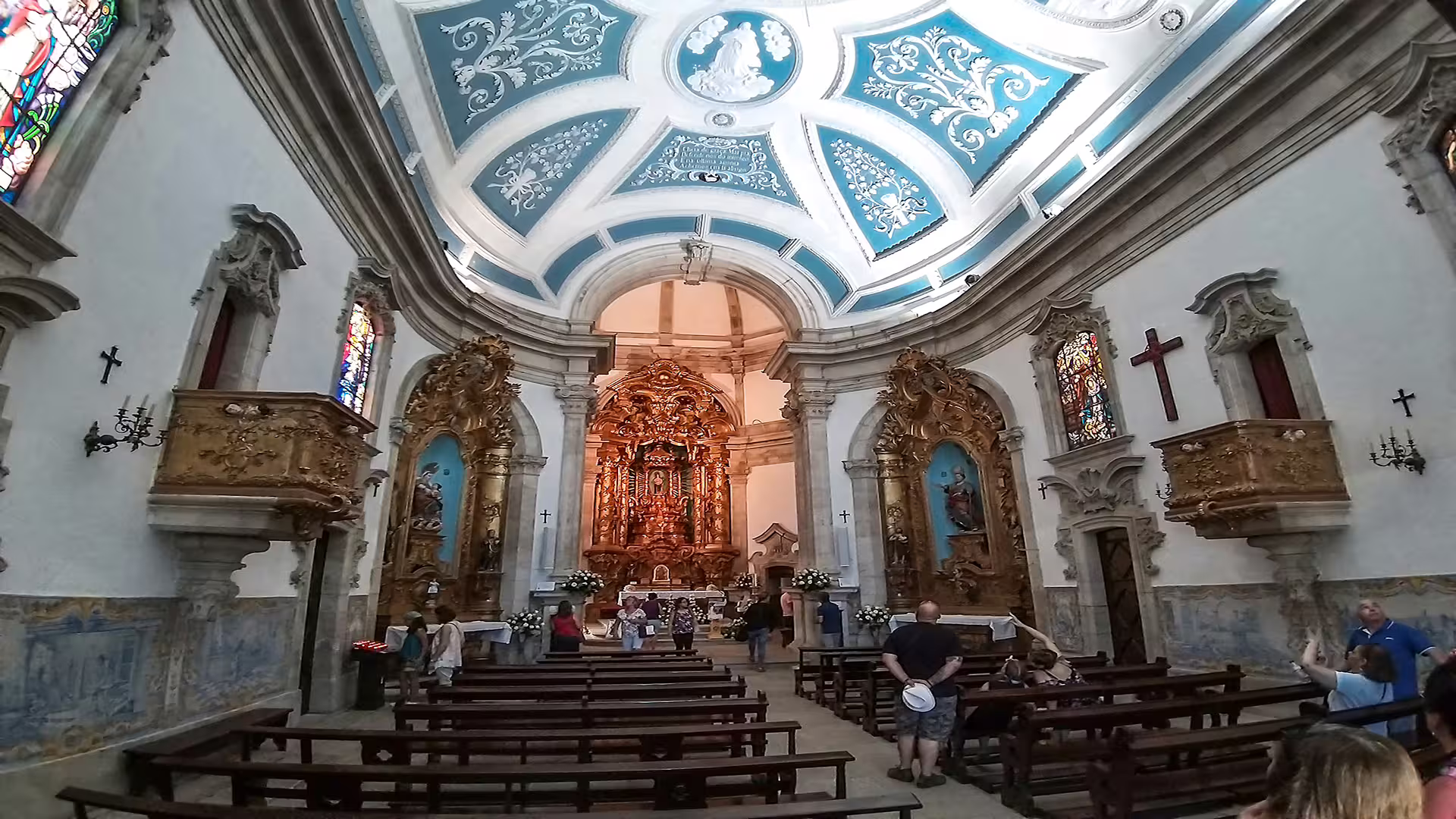 Ornate interior of a historic church in Lamego, Portugal, featuring intricate stained glass and gilded altarpieces on a private tour.