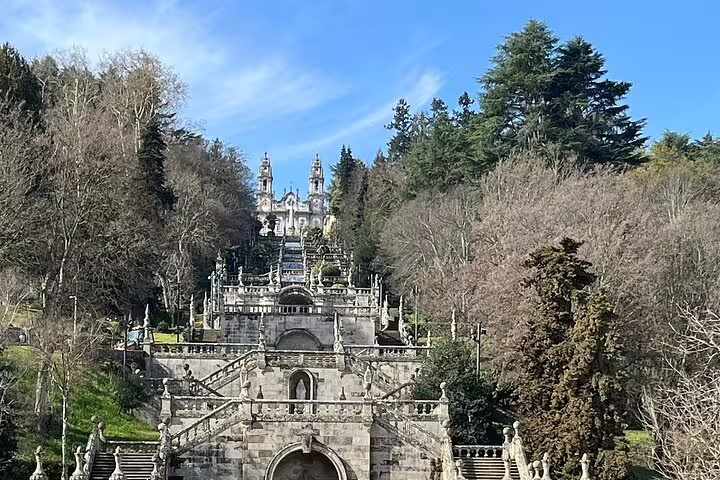 Stunning Lamego Sanctuary staircase surrounded by lush trees under a clear blue sky.