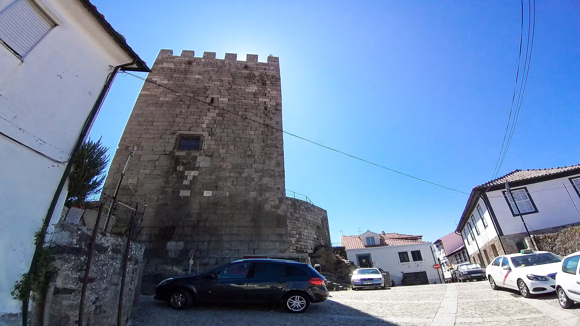 Historic stone tower in Lamego, Portugal, under a clear blue sky, part of a private tour exploring the Dão wine region.