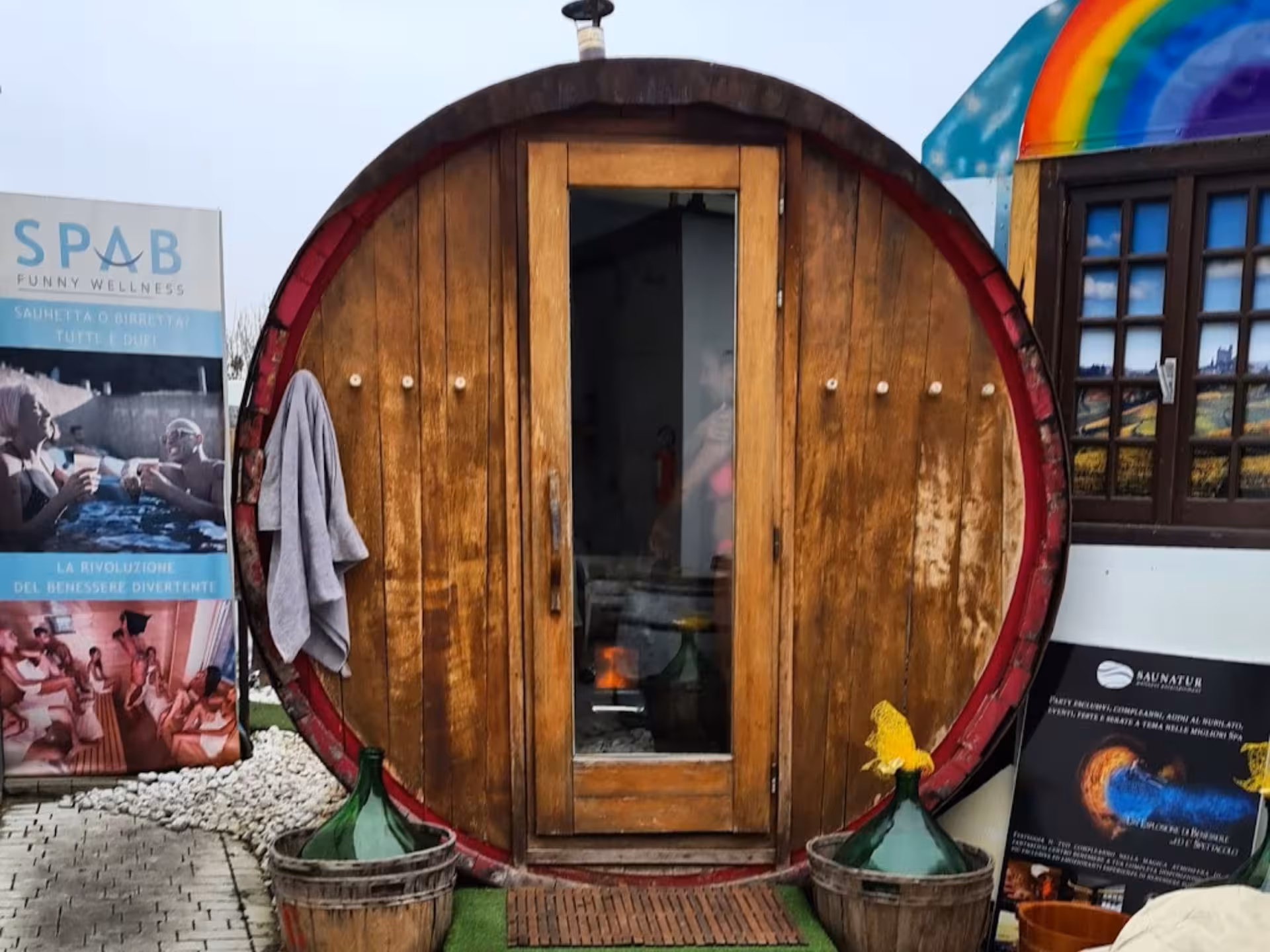 Wooden barrel sauna at Langhe Spa, offering a unique wellness experience with wine in a scenic setting.