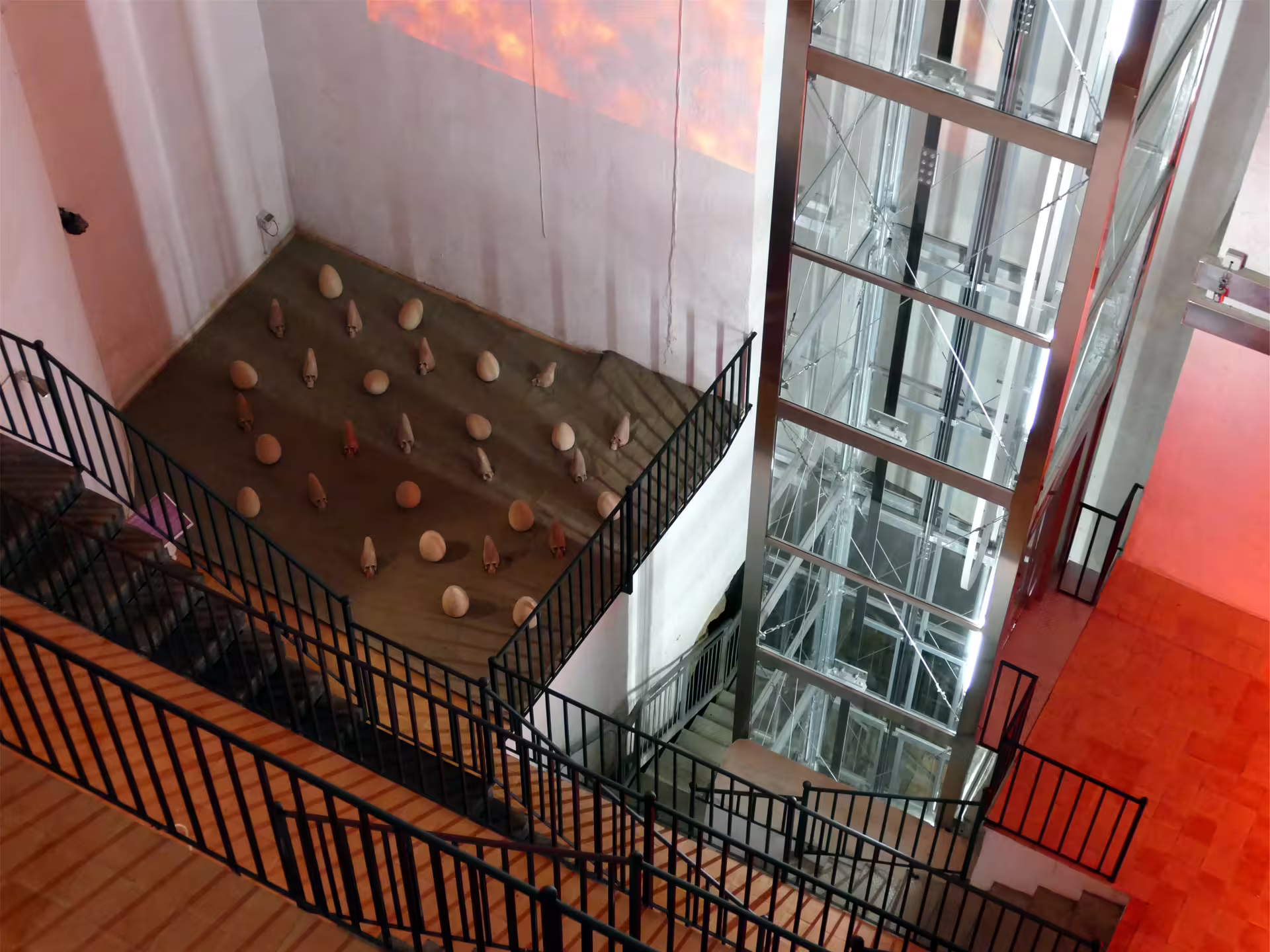 Modern stairways and glass lift descend into the Lapis Museum Naples, starting point for the Decumano Sommerso underground tour