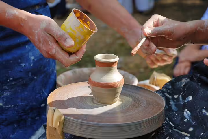 Hands crafting pottery on a wheel at a local workshop in the Lasithi Plateau during a private tour from Chania.