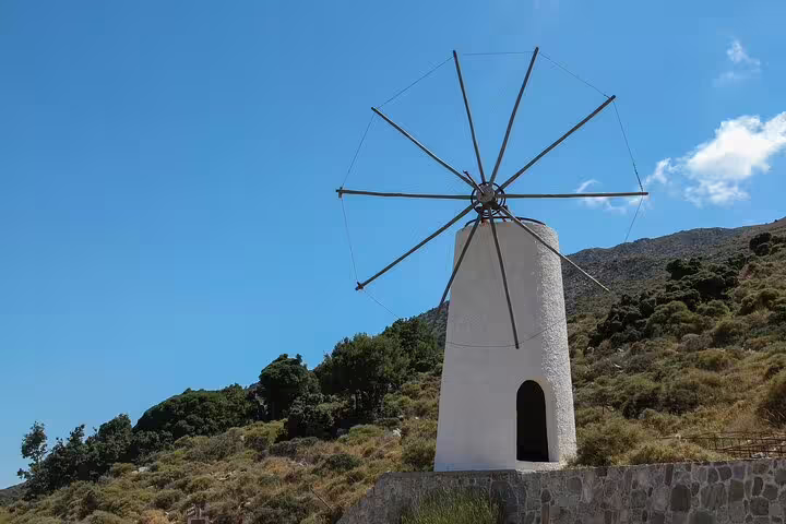 Traditional white windmill against a clear blue sky on the scenic Lasithi Plateau, Crete.