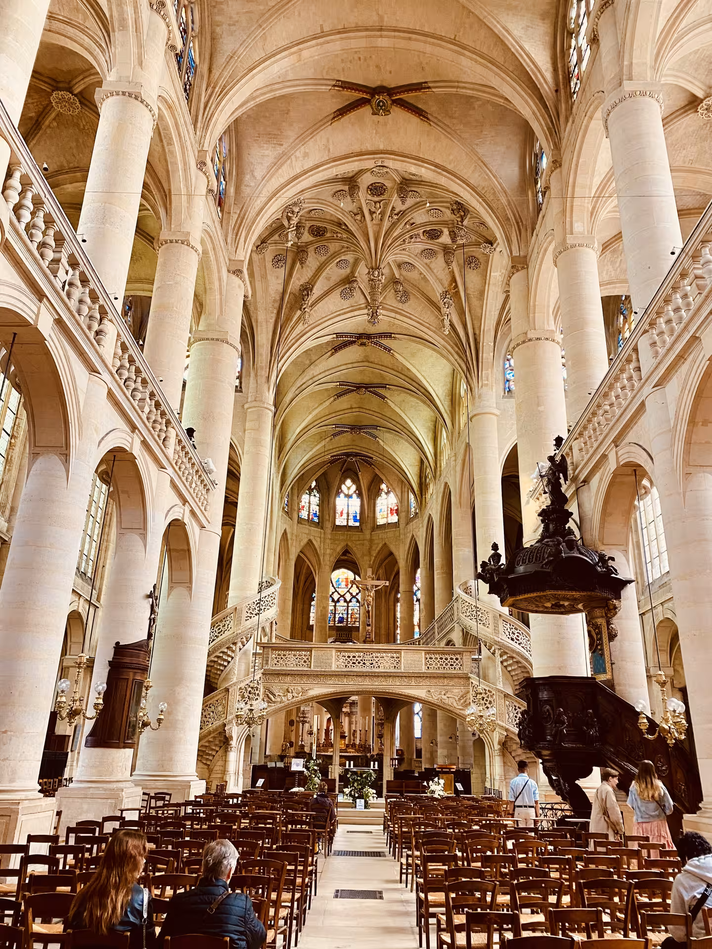 Explore the stunning Gothic architecture of a historic church in Paris' Latin Quarter, featuring majestic arches and stained glass.