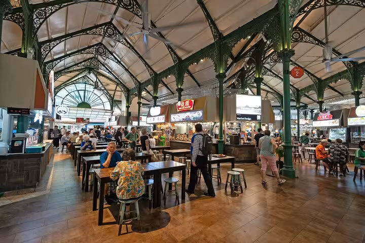 Lau Pa Sat food market in Singapore bustling with tourists and locals, offering diverse Asian cuisine and vibrant atmosphere.