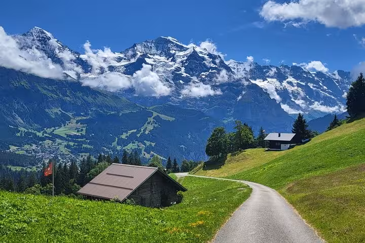 Scenic view of Lauterbrunnen village with Swiss Alps in the background on a sunny day, ideal for Swiss Alps tours.