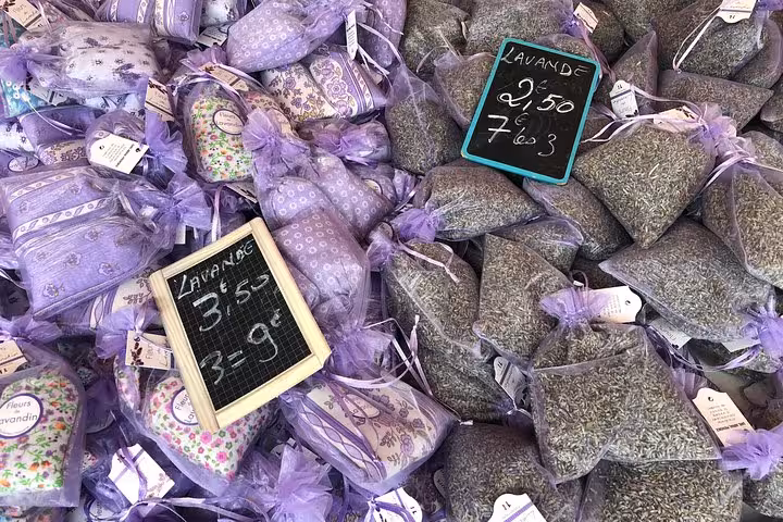 Lavender sachets and dried lavender bags for sale at a vibrant Old Town Nice market, showcasing local Provençal aromas.