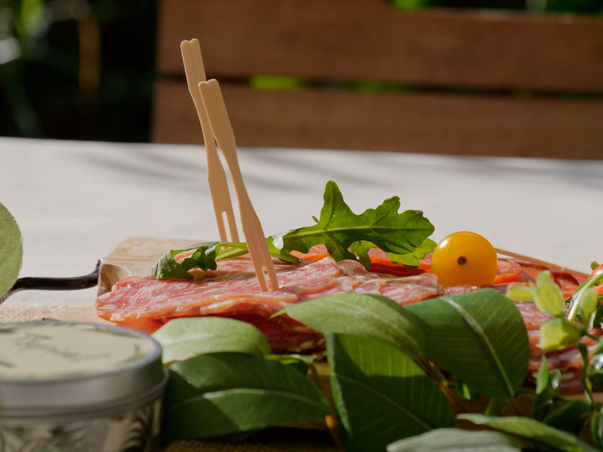 Gourmet salami platter with fresh greens and yellow cherry tomato, perfect for Le Castella boat tour picnic.
