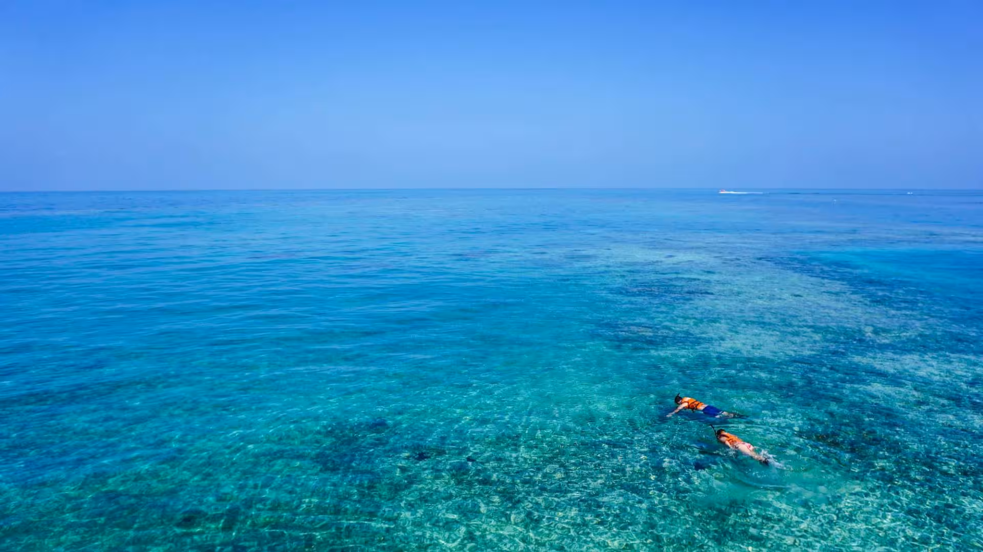 Two snorkelers explore the clear turquoise waters of Capo Rizzuto’s marine area, highlighting seabed beauty.