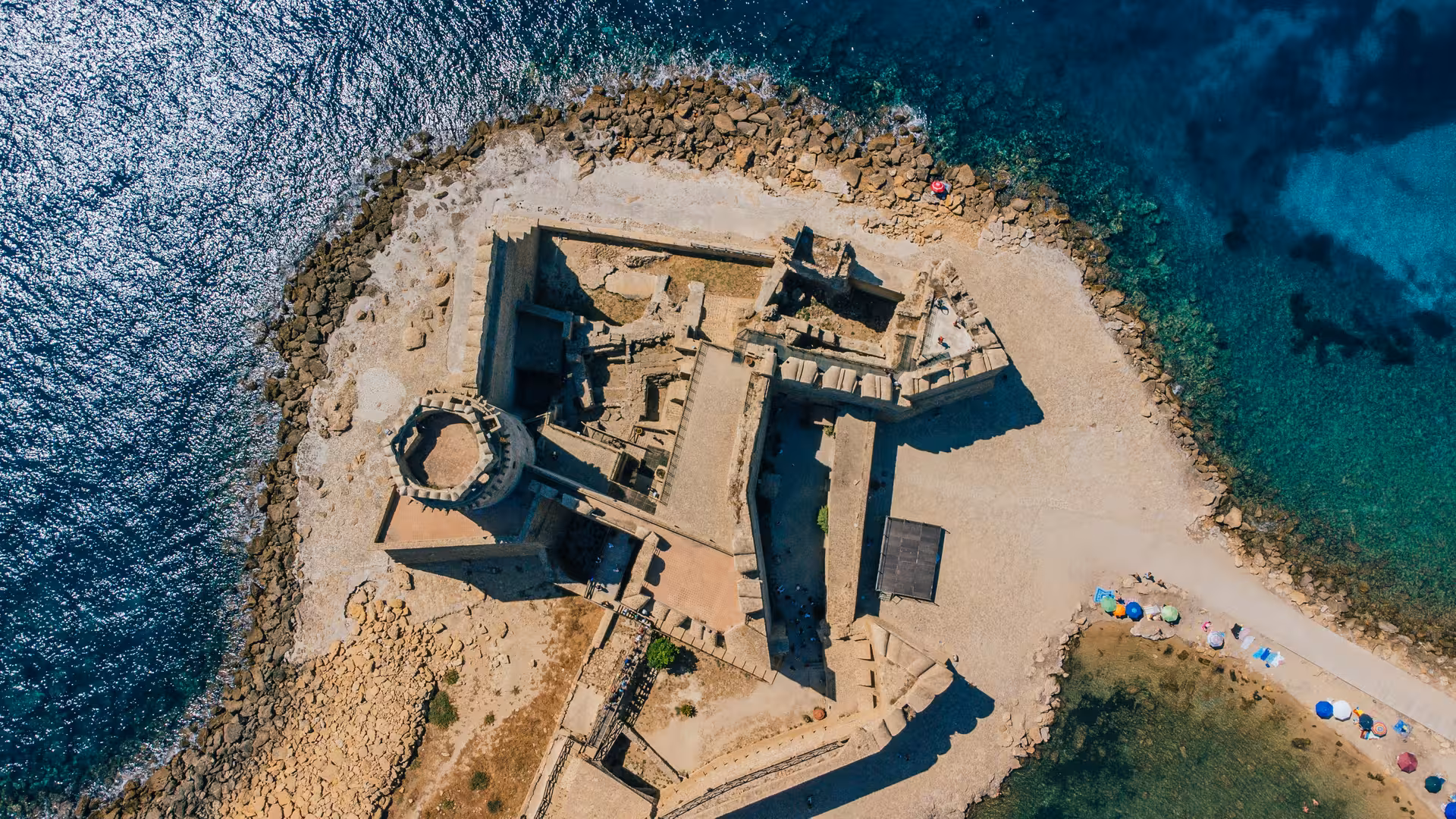 Drone view of Le Castella fortress surrounded by shimmering waters, a highlight of the Capo Rizzuto marine boat tour.