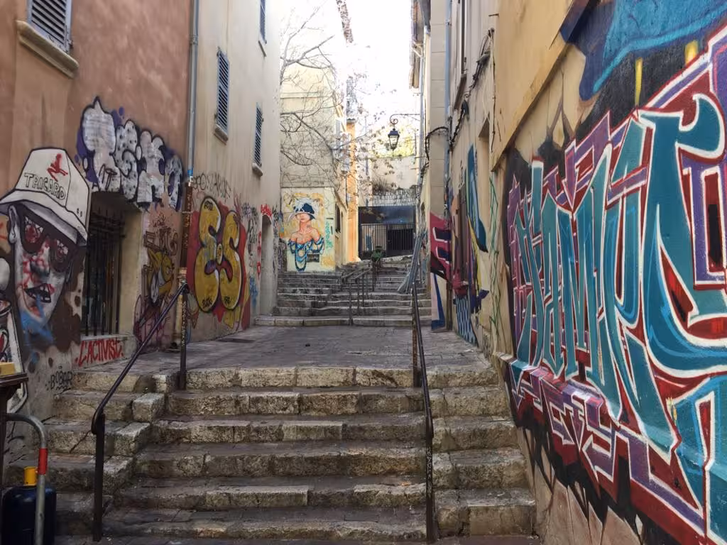 Graffiti-covered stone steps in Le Panier, Marseille, showcasing street art on guided walking tour of the old district