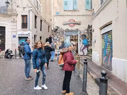 Le Panier alley with murals and shops, Marseille old town walking tour stop for street art and local culture