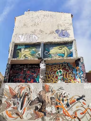 Graffiti-covered building façade in Le Panier, Marseille, showcasing vibrant street art on a walking tour