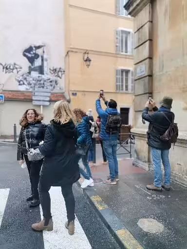 Visitors photographing street art in Le Panier, Marseille’s oldest district on a guided walking tour experience