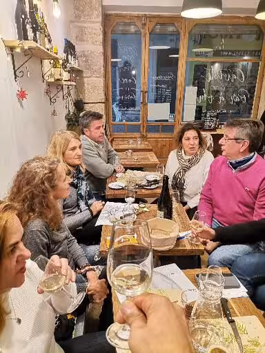 Guests tasting wine in a cozy Marseille bistro during Le Panier walking tour in the oldest neighbourhood