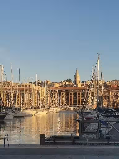 Old Port Marseille view with sailboats and waterfront skyline, gateway to Le Panier walking tour